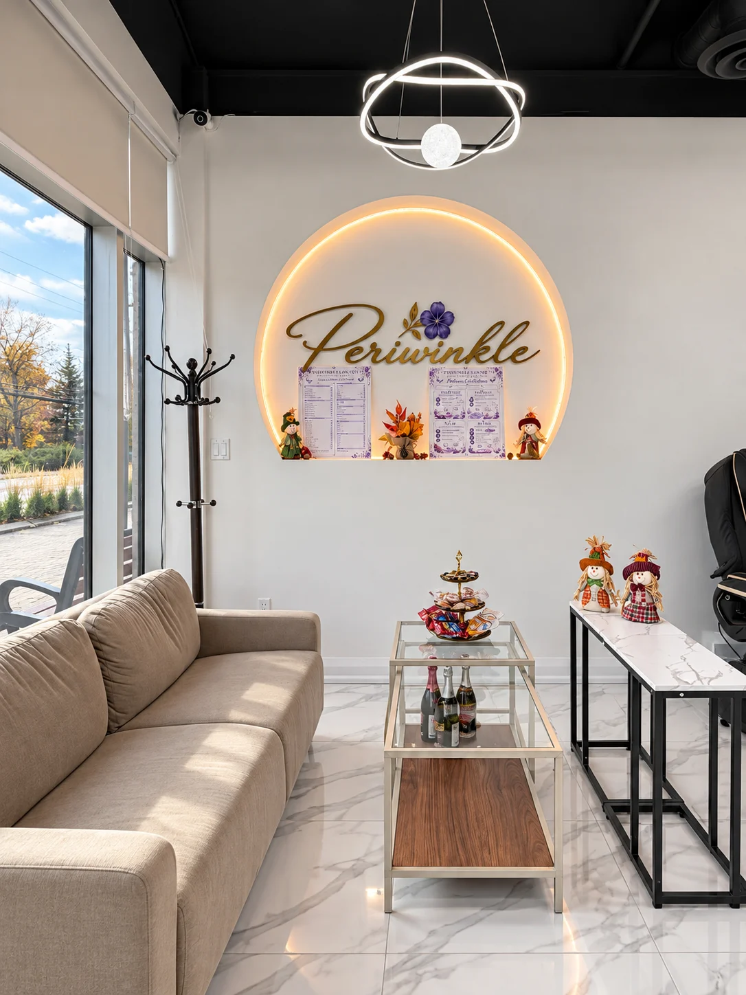 The Periwinkle welcome lounge with a golden illuminated sign and comfortable seating